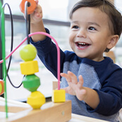 young boy playing with a toy